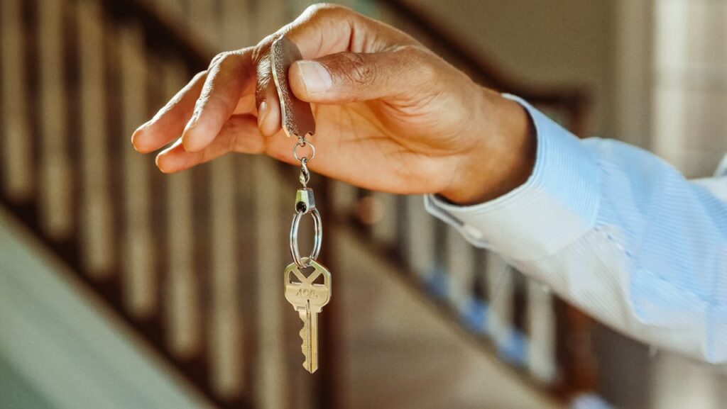 person holding keys inside house
