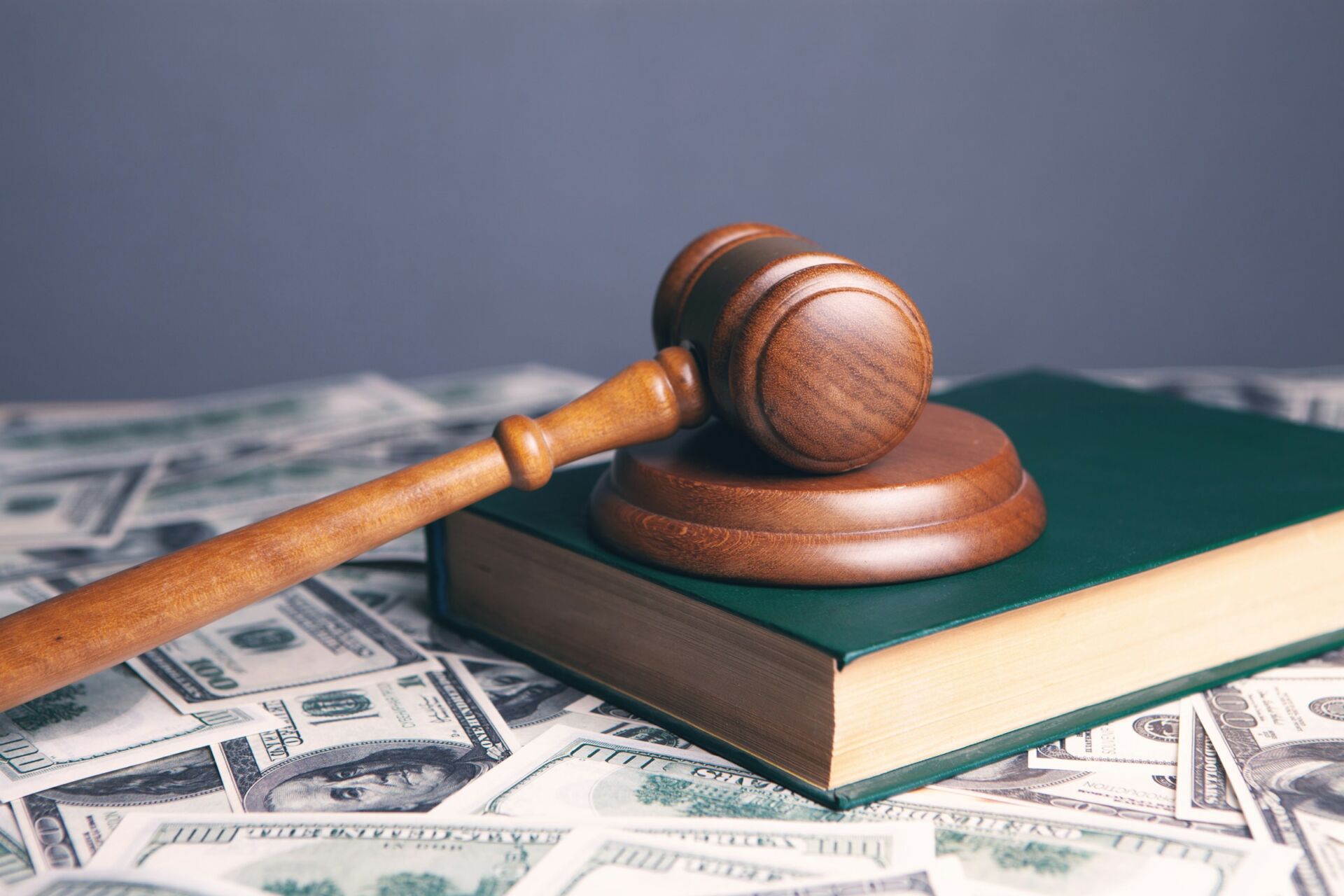 Gavel on law book with money representing California AB 1482 rent increase law